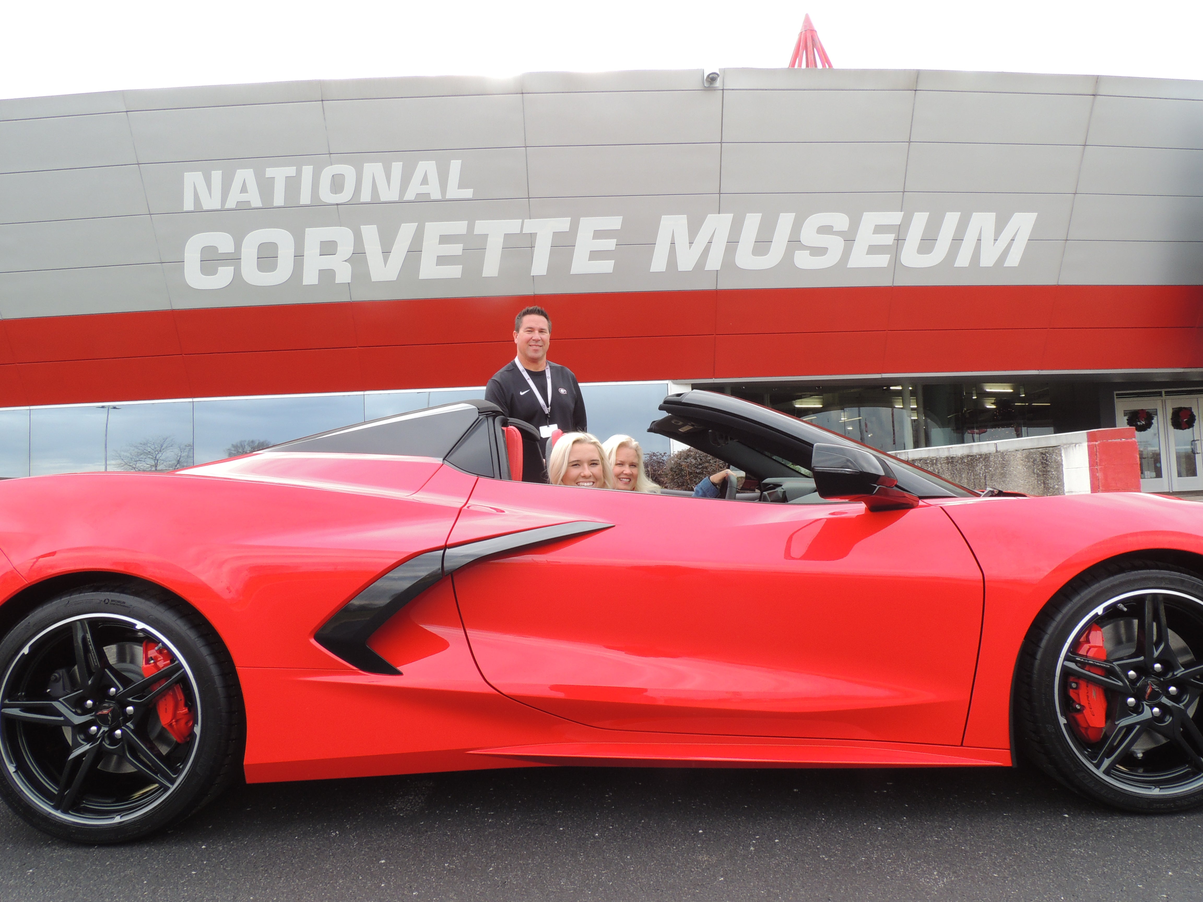 R8C Delivery Customers in a torch red Corvette