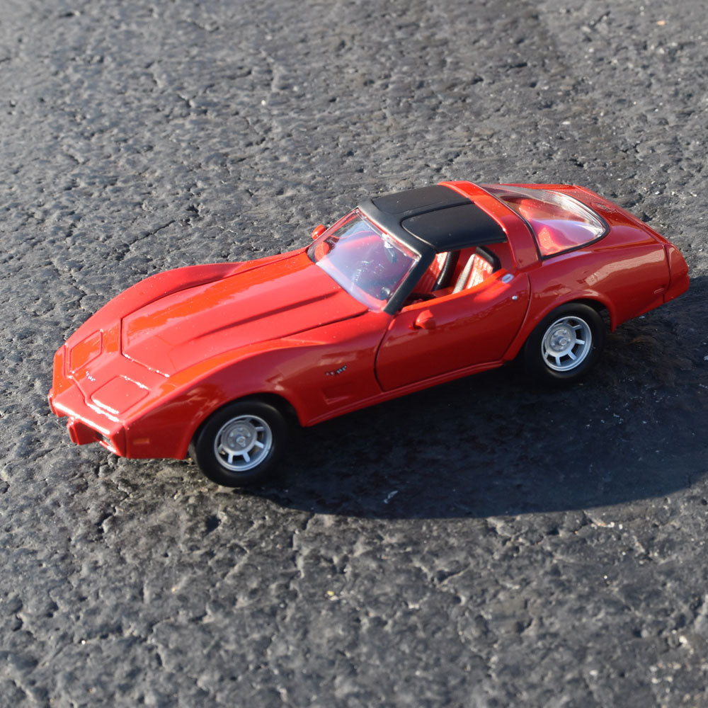 1979 Corvette Red Diecast Model displayed on a road
