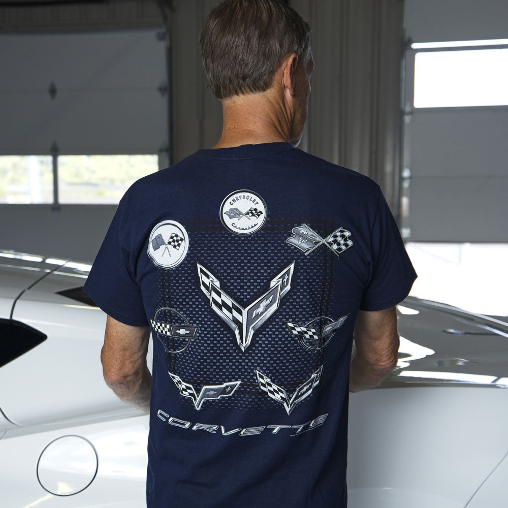 Man standing in a garage next to a white Corvette wearing the Navy Blue 1st-8th Generation Emblems Circle T-shirt