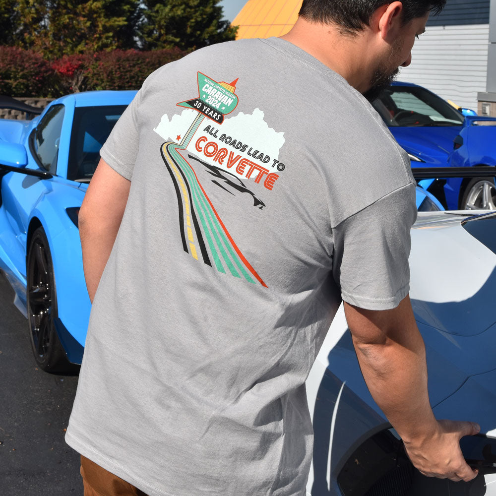 Man wearing the 2024 NCM Caravan All Roads Lead to Corvette Gray T-shirt