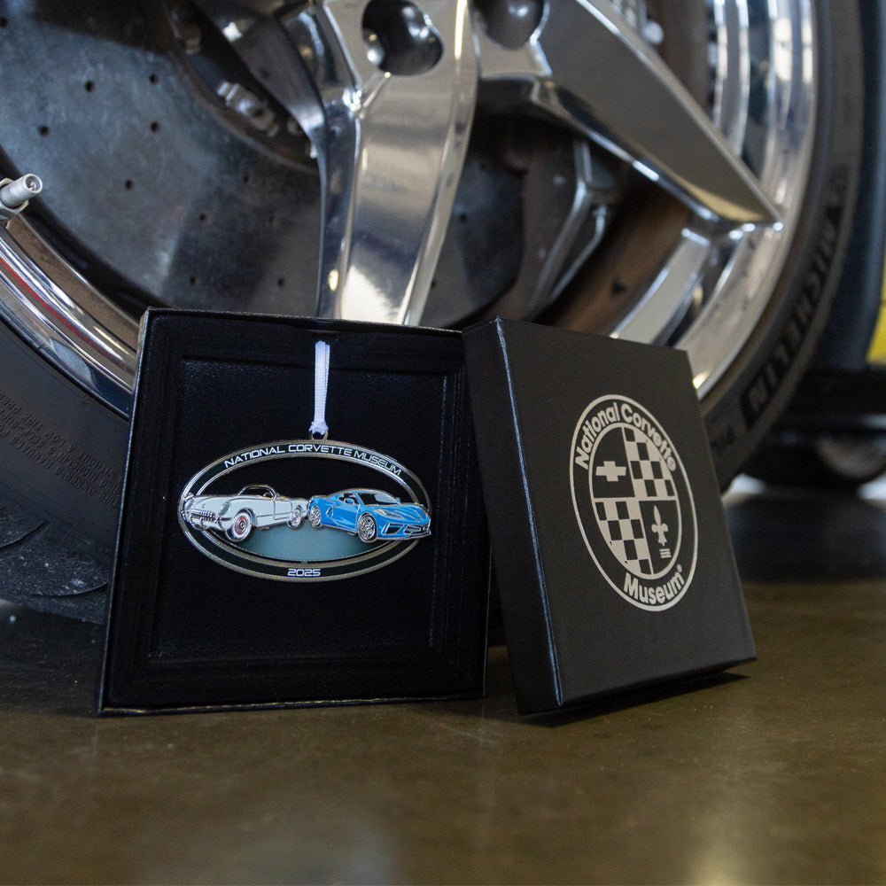 Image of the 2025 NCM Ornament displayed in front of a C8 Corvette tire