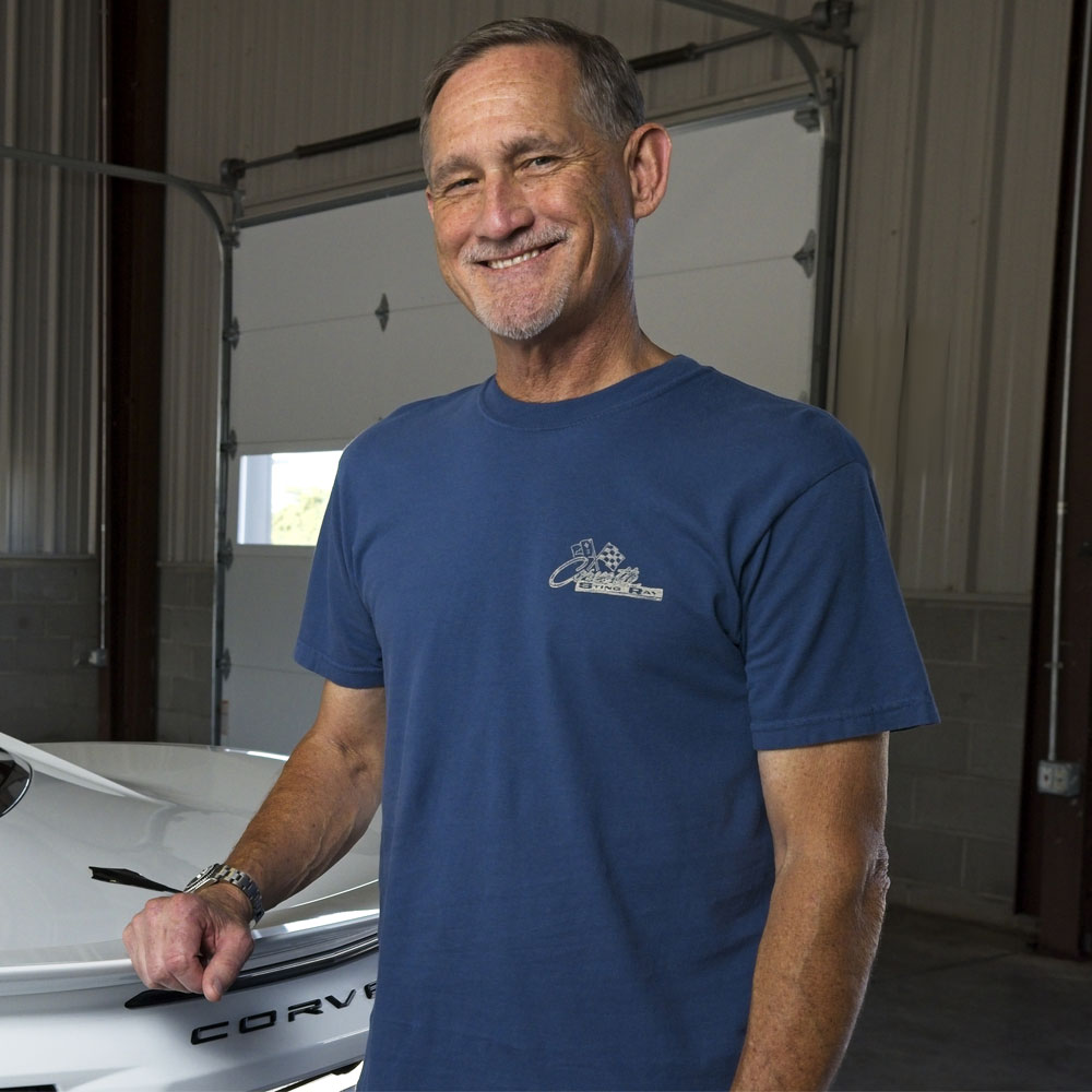 Man standing next to a white Corvette wearing the 2nd Generation Corvette 67 Big Block Sting Ray T-shirt