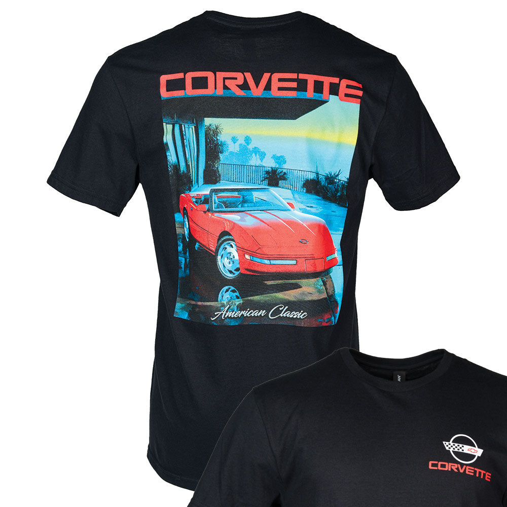 Black t-shirt with a red C4 Corvette convertible parked in front of an ocean scene on the back and a small C4 Corvette emblem on the front of the t-shirt.