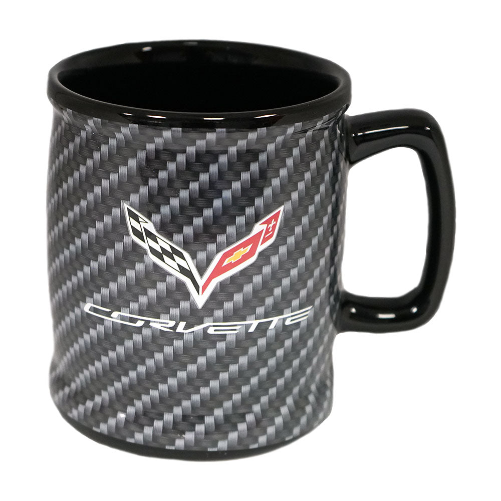 A ceramic mug with a black and gray carbon fiber pattern exterior, a glossy black handle and interior, featuring the C7 Corvette logo printed on the front.
