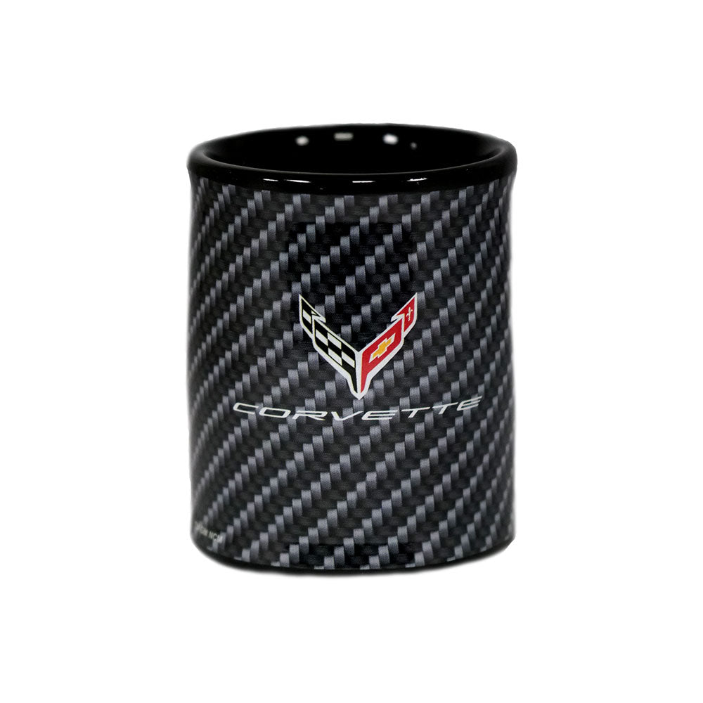A black ceramic shot glass featuring a carbon fiber pattern and a C8 Corvette emblem on the front, set against a plain white background.