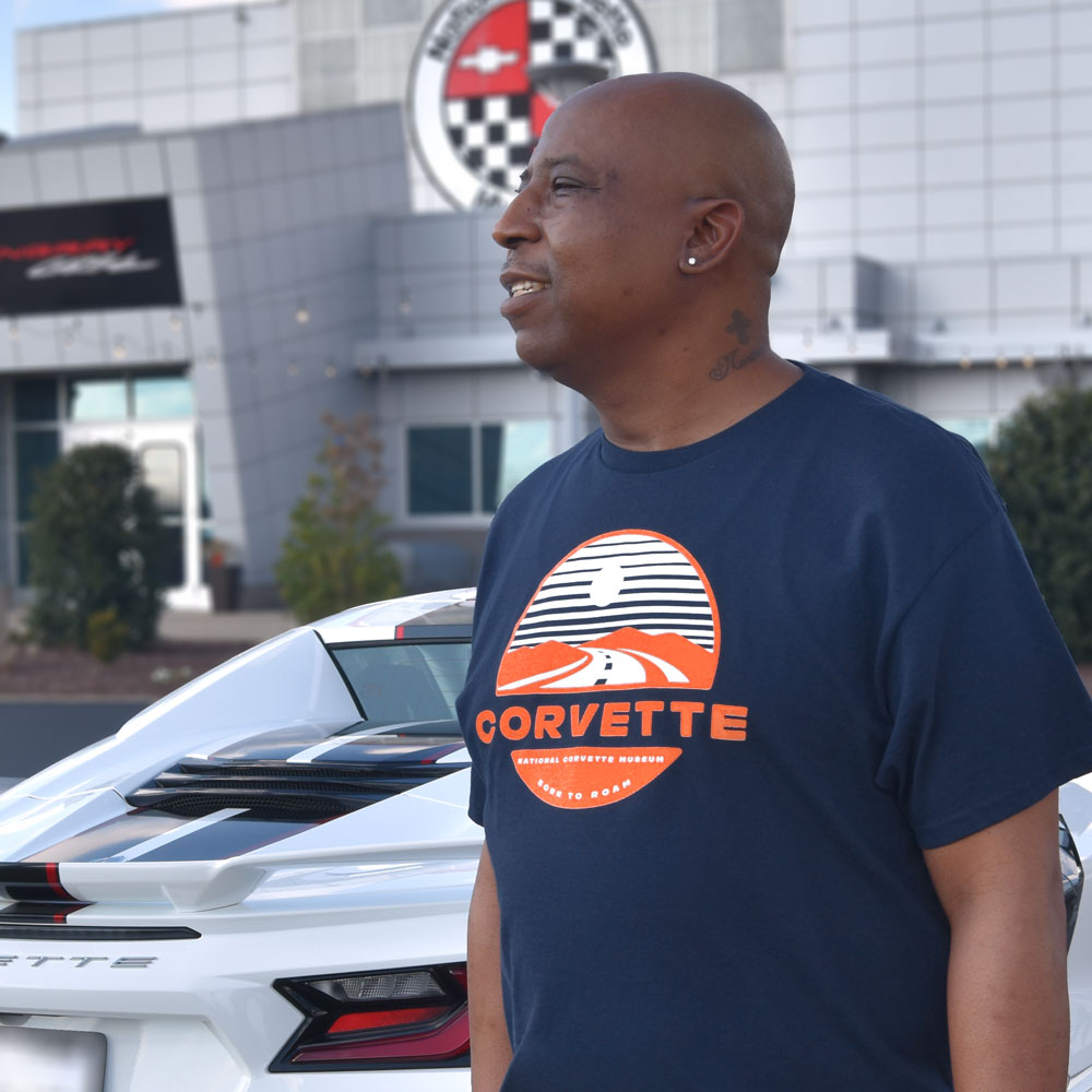 Man wearing the Born to Roam Corvette Navy T-shirt