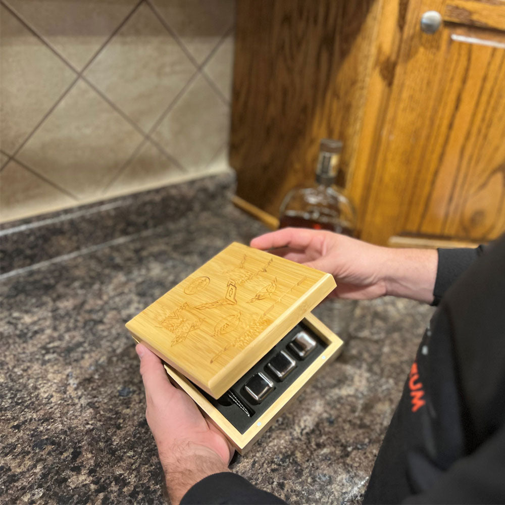 Person holding the C1-C8 Corvette Emblems Whiskey Stone Set