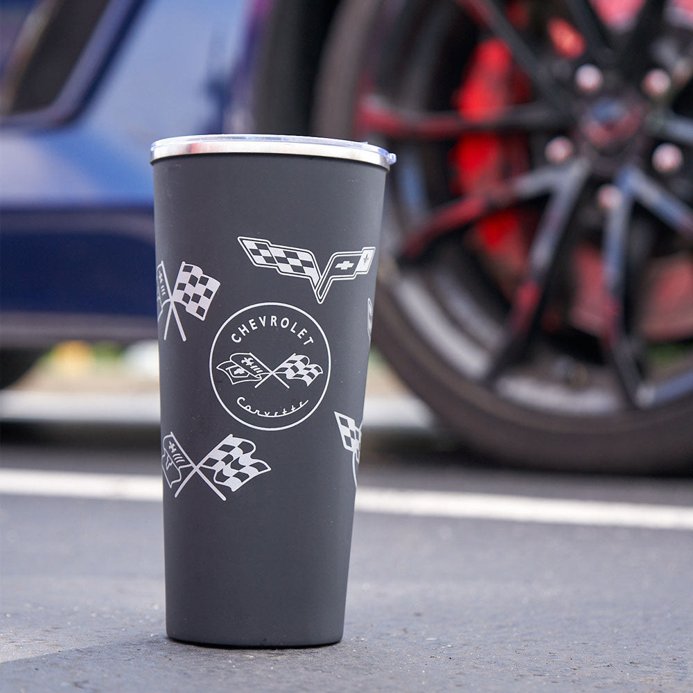 C1-C8 Corvette Stainless Steel Black Travel Mug sitting in front of a car