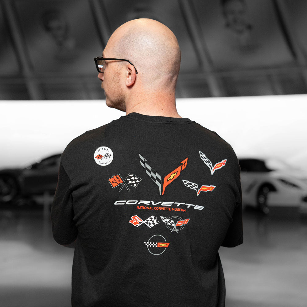 Man wearing the C1-C8 Emblems V-Back T-shirt showing all eight Corvette emblems on the back