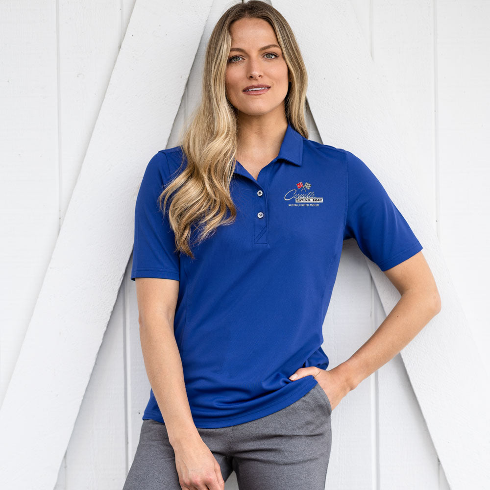 Woman wearing the C2 Corvette Emblem Ladies Core Tour Blue Virtue Polo