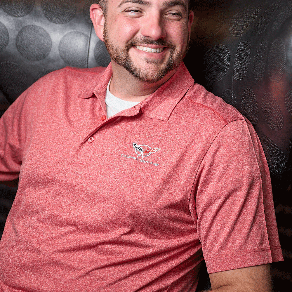 Person wearing C5 Corvette Men's Charge Active Cardinal Red Polo