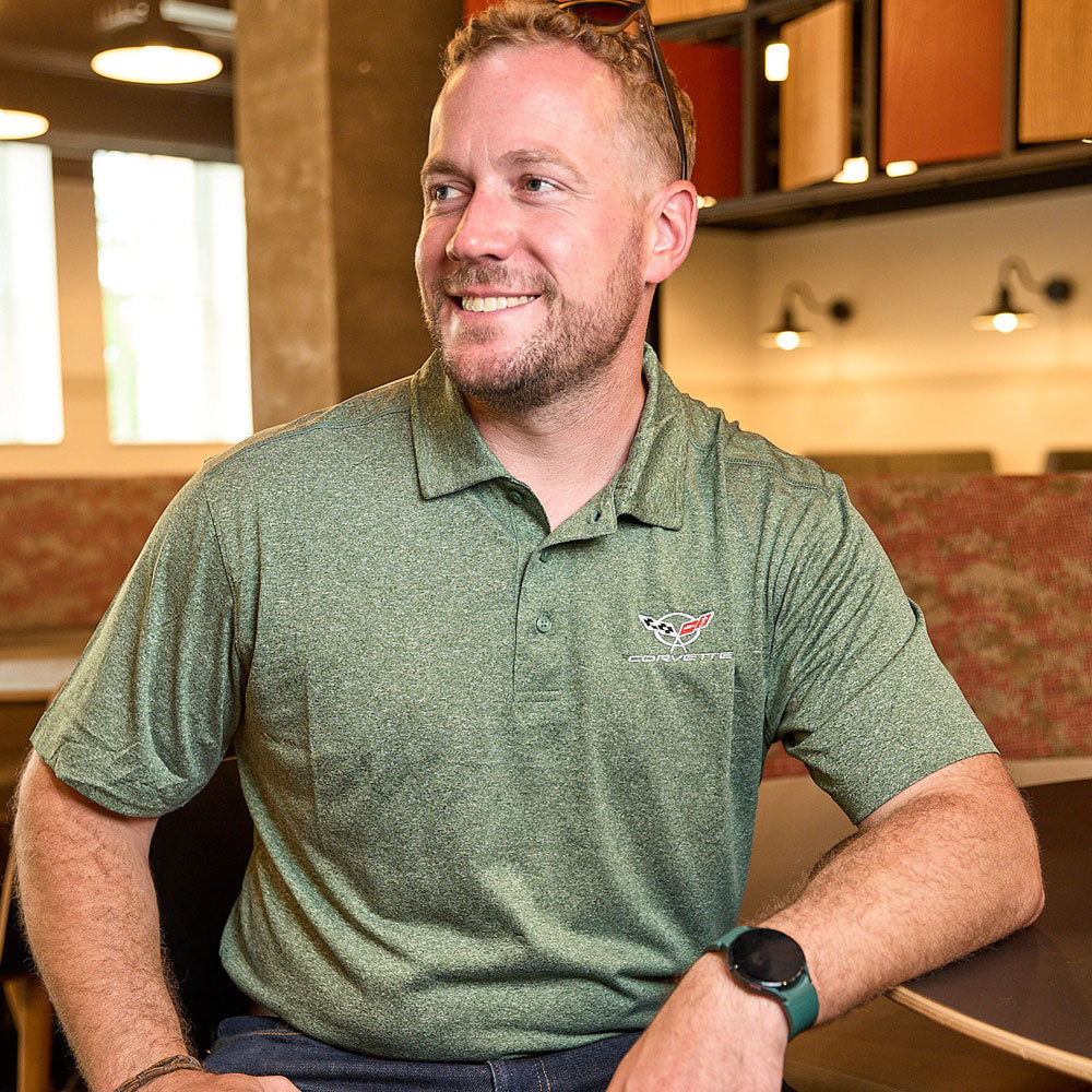 Man wearing the C5 Corvette Mens Charge Active Bottle Green Polo