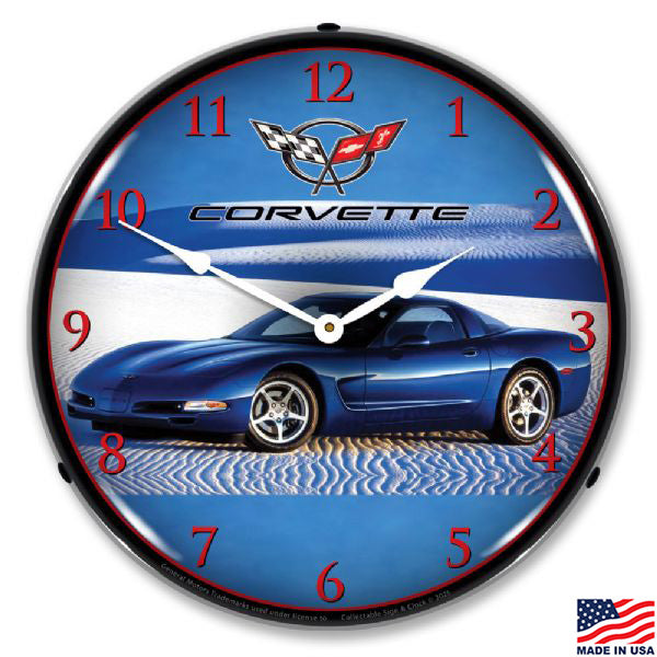 Clock that features a blue C5 Corvette on white sand with red numerals on the clock face