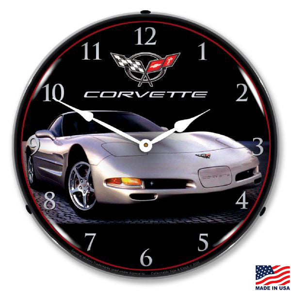 Corvette clock with a silver Corvette design on a black background