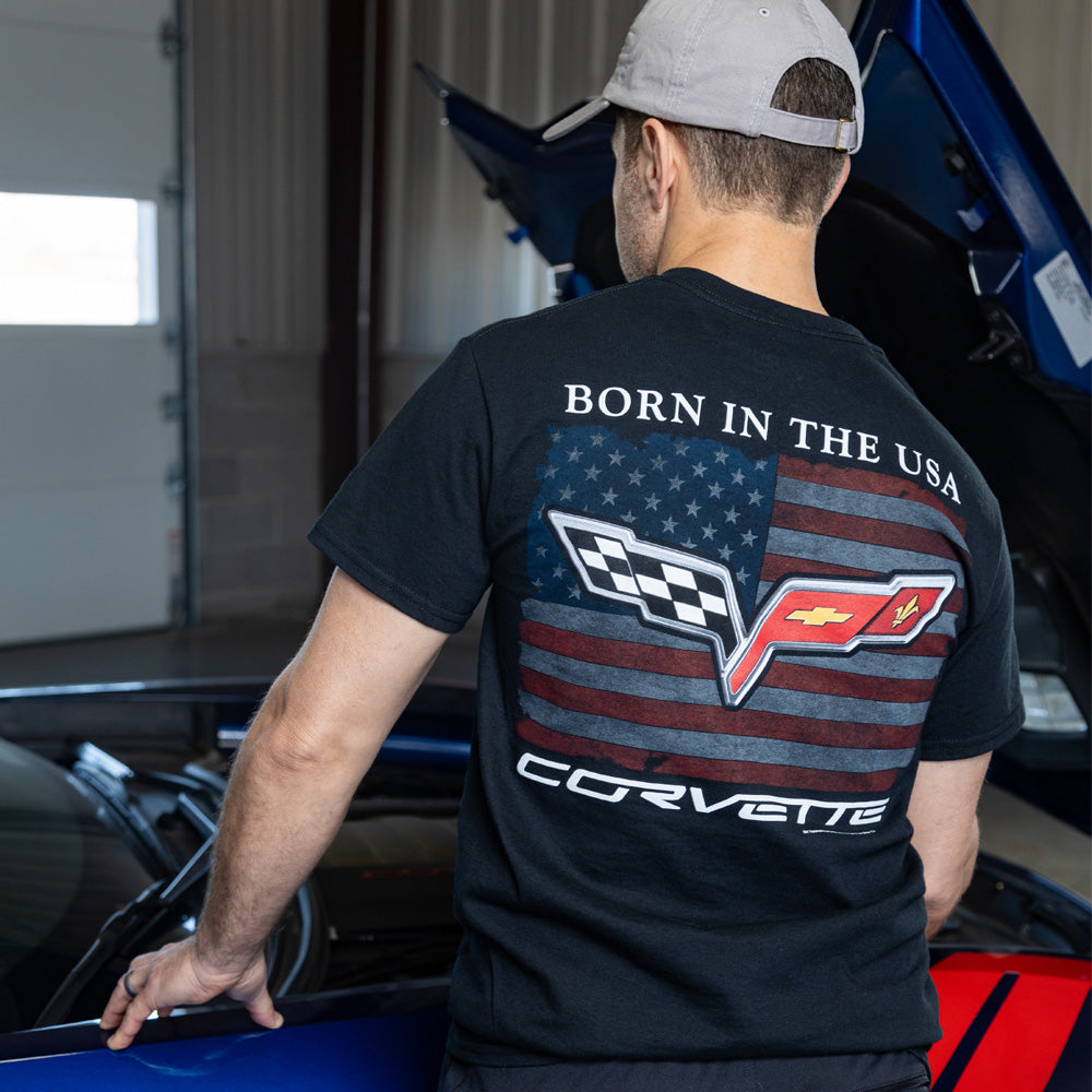 Man standing looking at the engine of a Corvette wearing the C6 Born in the USA Black Tee