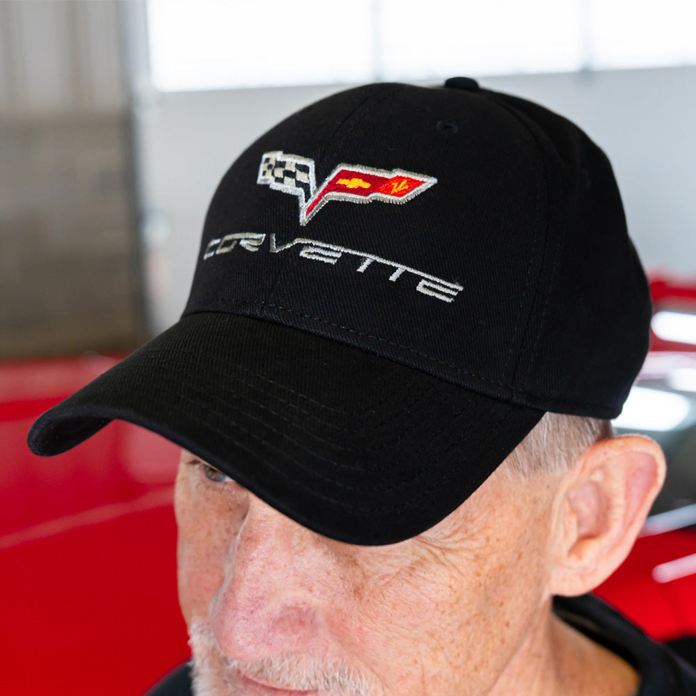 Person wearing a black Corvette cap with a C6 Corvette emblem.