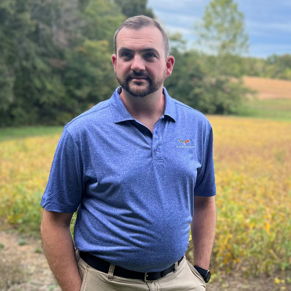 A man wearing C6 Corvette Charge Blue Heather Polo