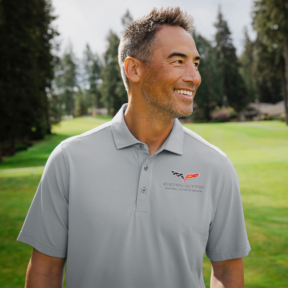 Man standing on a golf course wearing the gray C6 Corvette Custom Virtue Polo