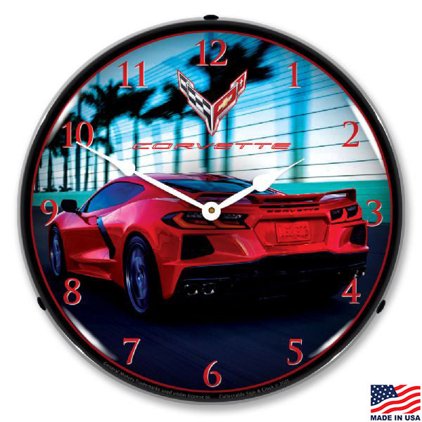 Wall clock with a red Corvette car design driving down a palm tree lined road
