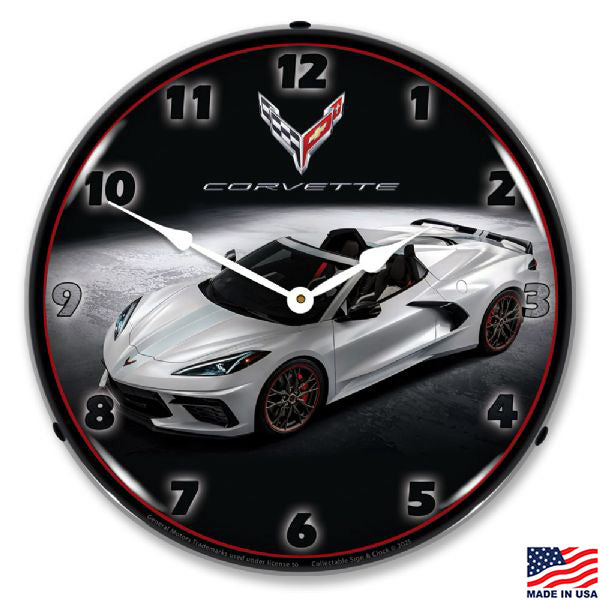 Wall clock with a white C8 Corvette design against a black background