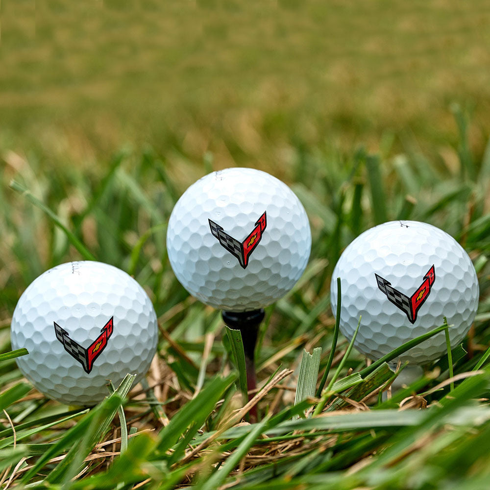 C8 Corvette Emblem Golf Ball Three Pack sitting in the grass