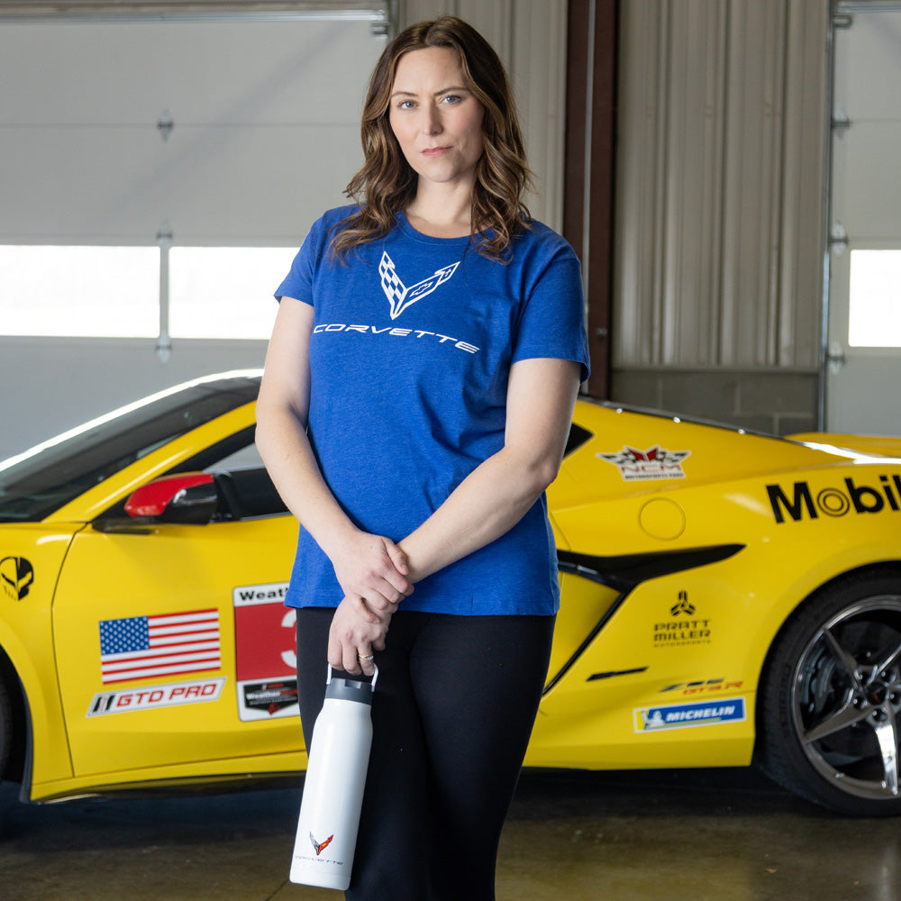 Woman standing in front of a yellow Corvette wearing the C8 Corvette Emblem Ladies Royal Blue Top