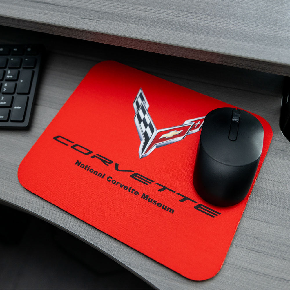 C8 Corvette Emblem Red Mouse Pad shown placed on a desk next to a keyboard