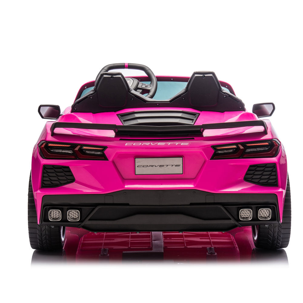 A bright pink Corvette convertible ride-on toy car shown from the rear on a clean white background.