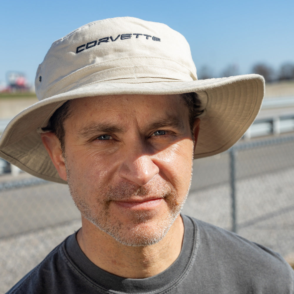 Man standing outside wearing the C8 Corvette Script Beige Bucket Hat