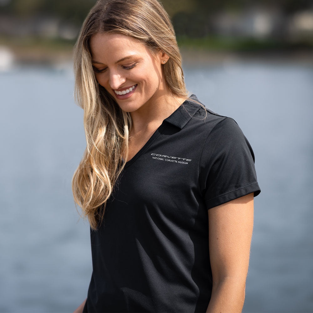 Woman wearing the C8 Corvette Script Ladies Black Daybreak Polo