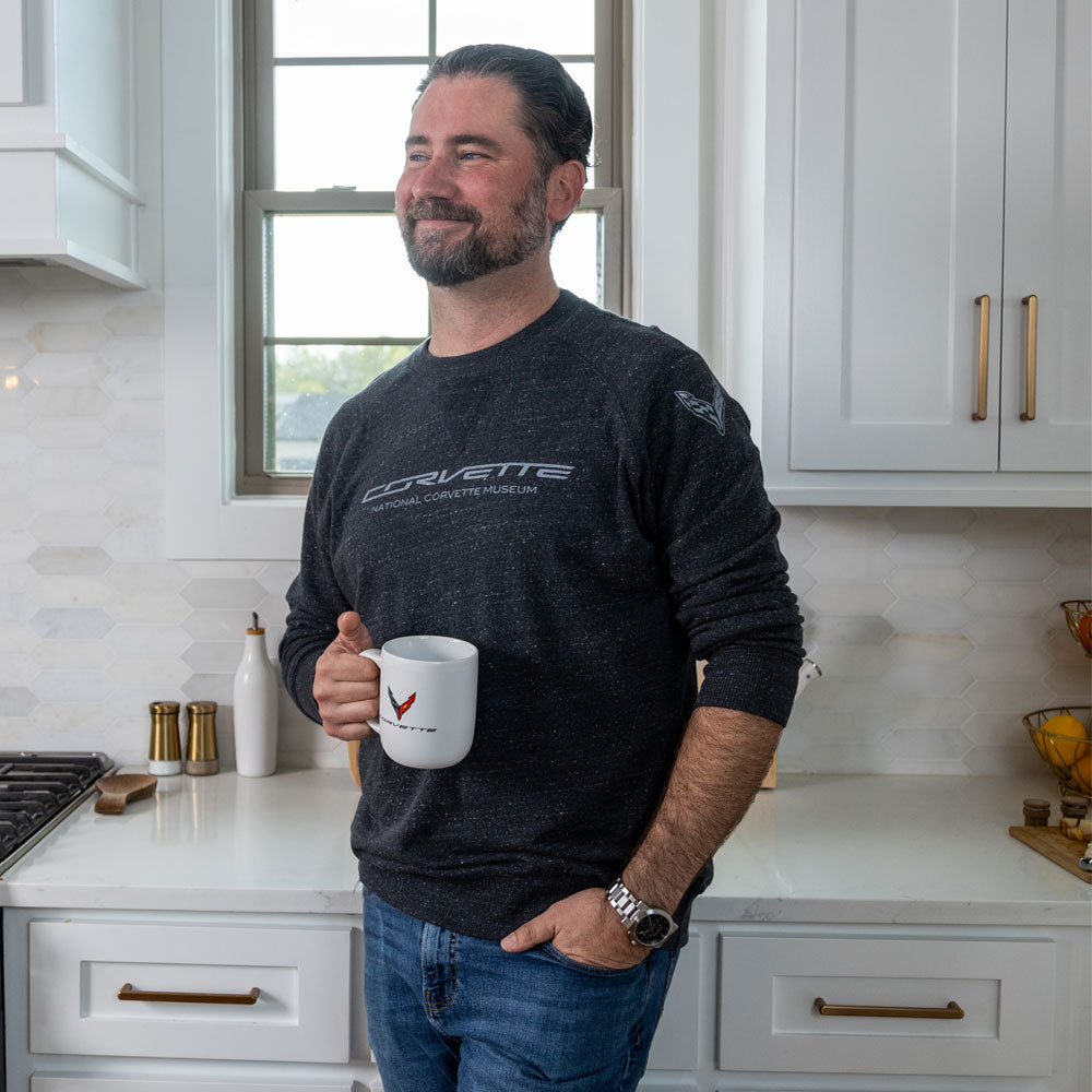 Man standing in a kitchen drinking coffee wearing the C8 Corvette Terry Crew Pullover