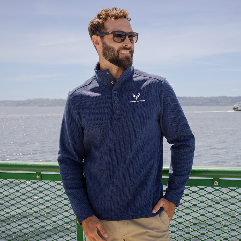 Man standing on a dock wearing the C8 Corvette Textured Fleece Snap Front Navy Pullover