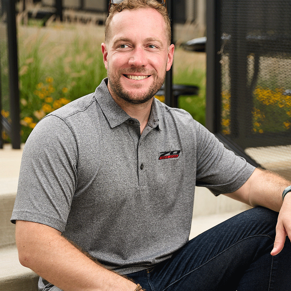 Person wearing Corvette 70th Anniversary Men's Forge Polo