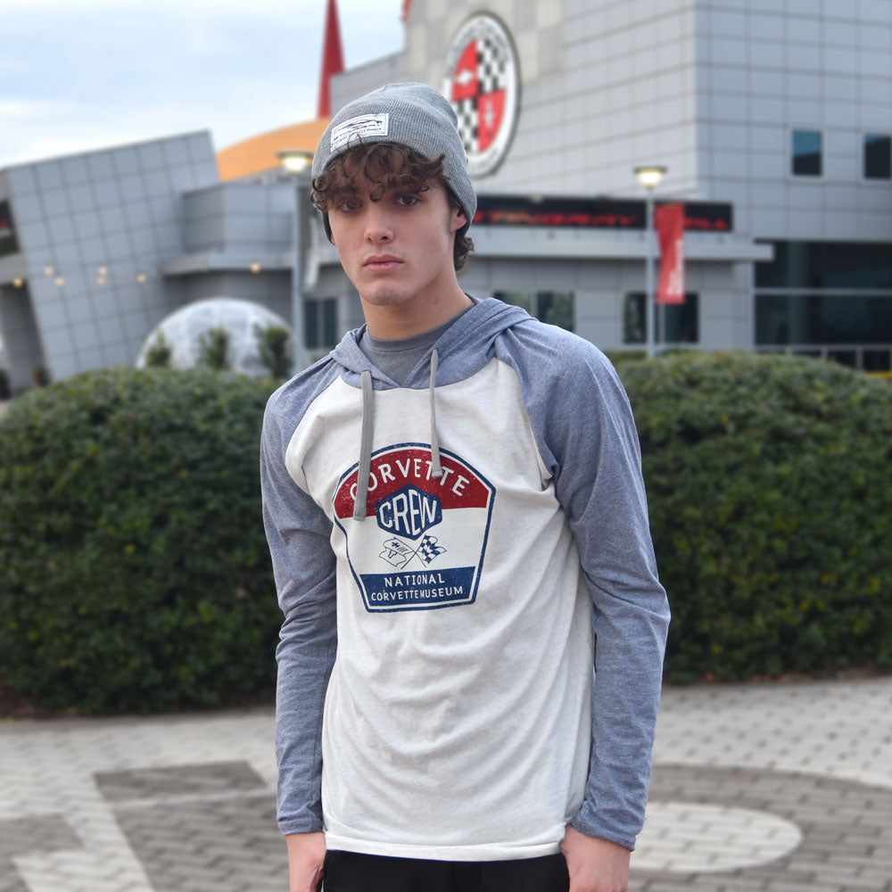 Man standing in front of the National Corvette Museum wearing the Corvette Crew Raglan Hoodie T-shirt