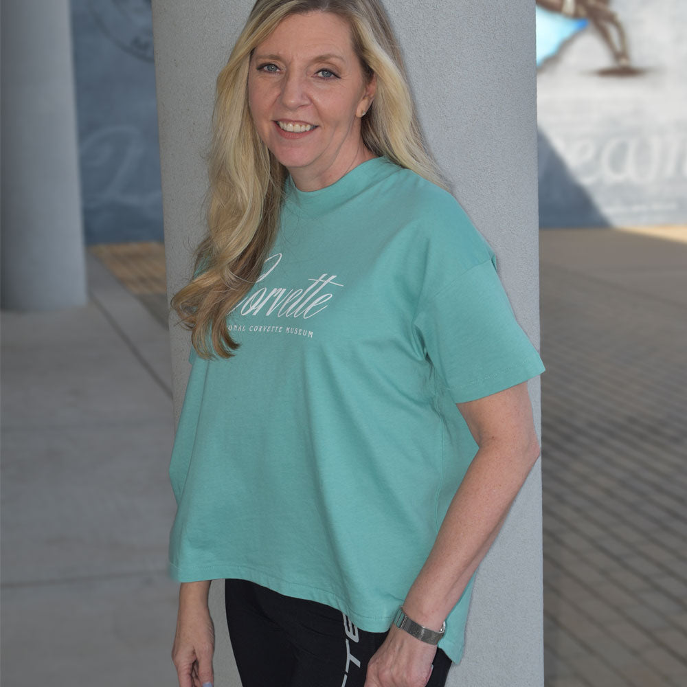 Woman wearing the Corvette Ladies High Low Caribbean Green Top 