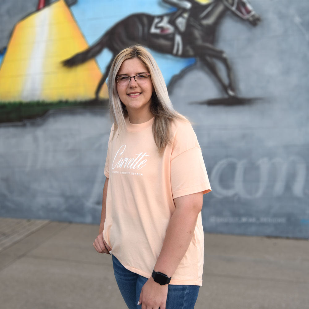 Woman wearing the Corvette Ladies High-Low Peach Top