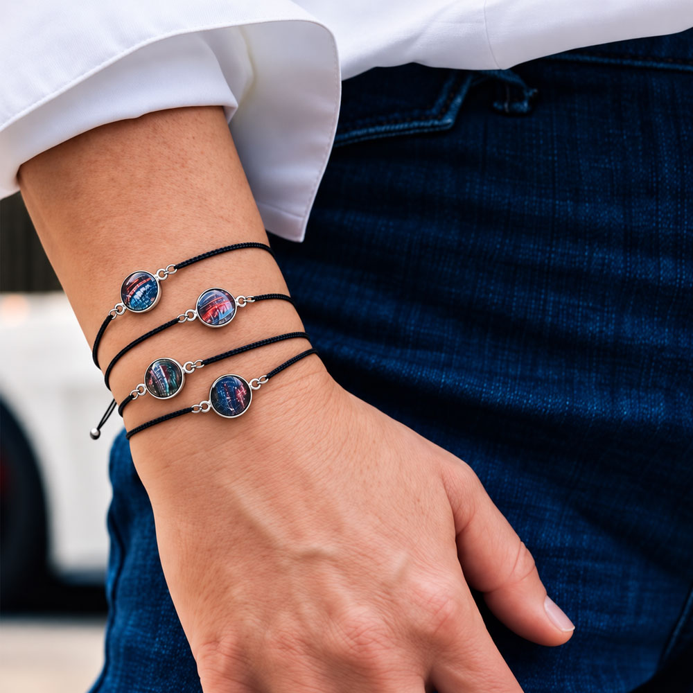 A close up of a woman's arm wearing four of the Corvette Paint Taylor Cord Bracelet stacked together.