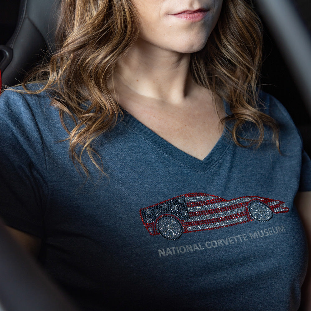 Woman sitting in a Corvette wearing the Corvette Rhinestone American Flag Navy Top