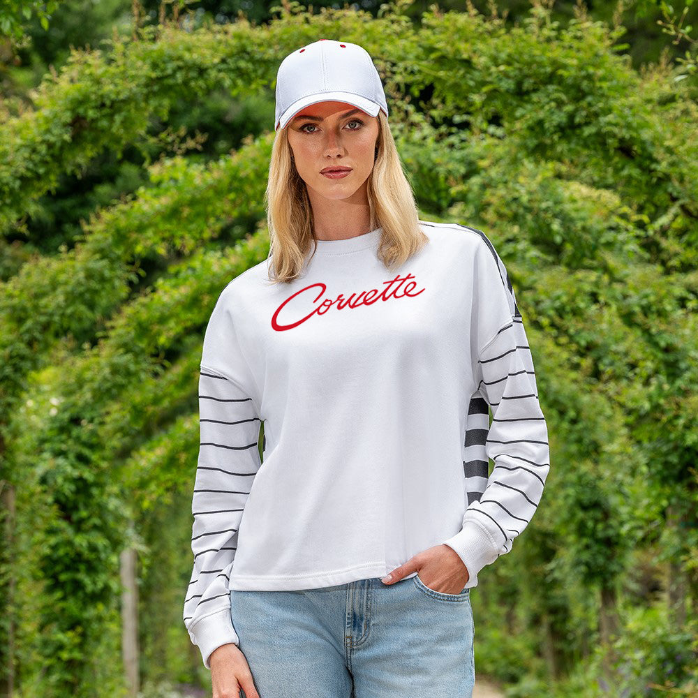 Woman wearing the Striped Ladies Long Sleeve Top with 'Corvette' text and a cap, standing outdoors.