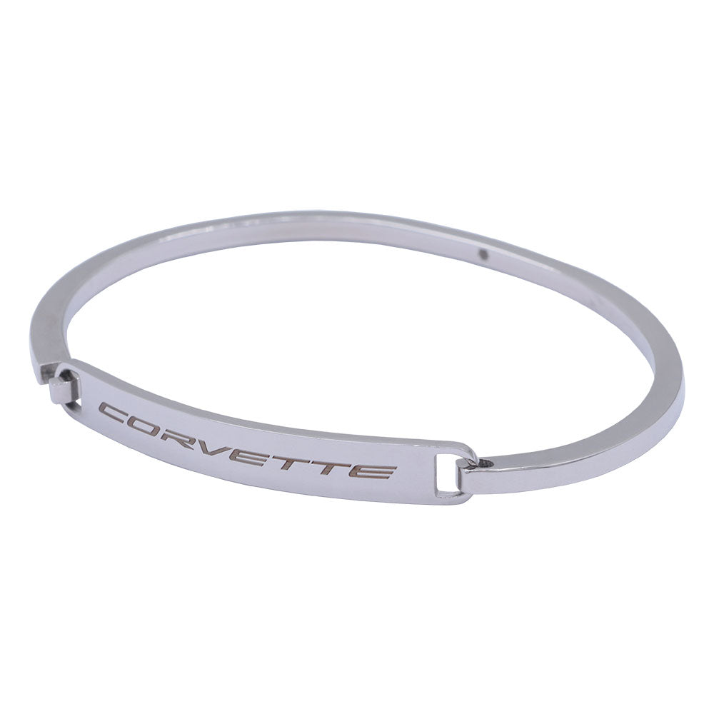 A silver-toned metal bangle bracelet featuring the word 'CORVETTE' engraved on its front band, set against a plain white background.