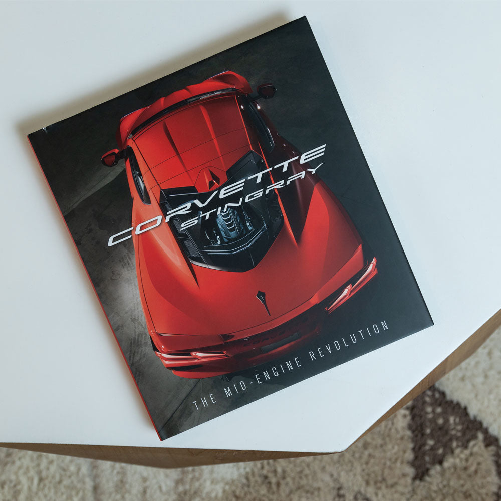 The Corvette Stingray The Mid-Engine Revolution book shown on a coffee table