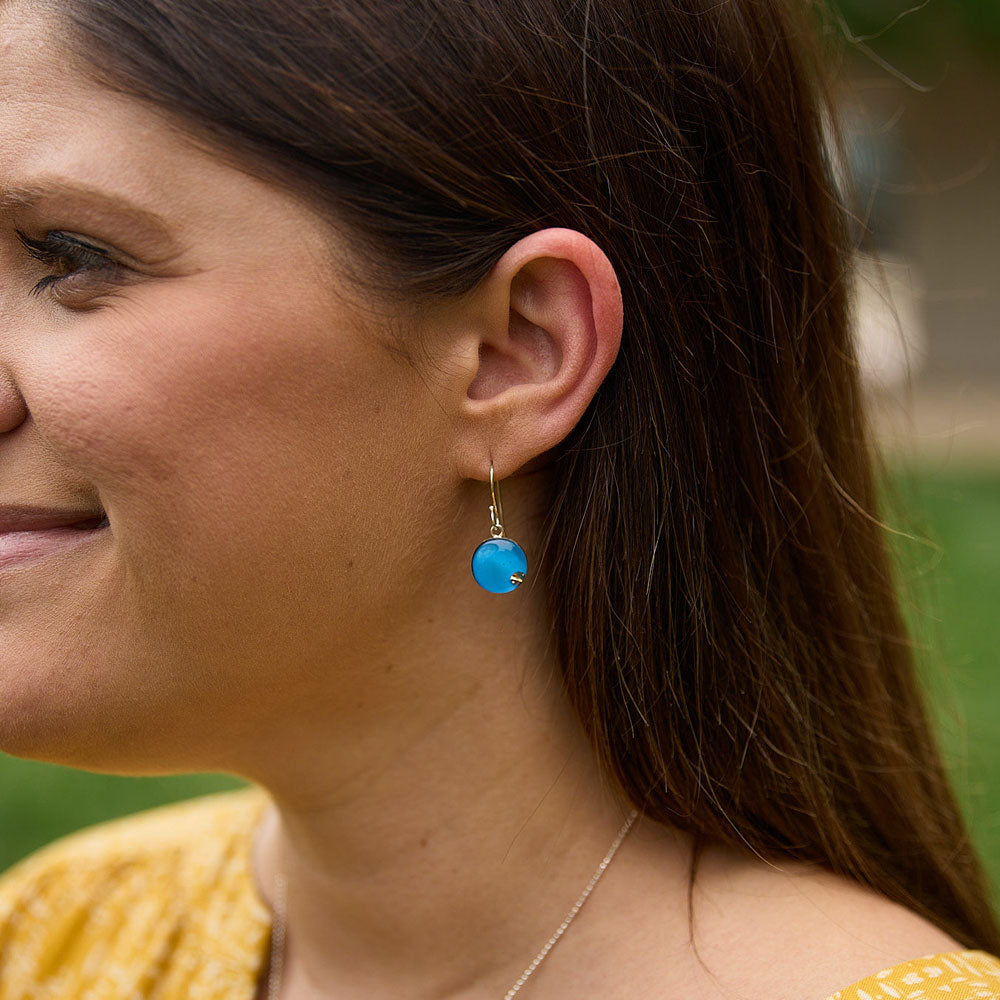 Model wearing the Crash Jewelry Rapid Blue Dangle Circle Earrings