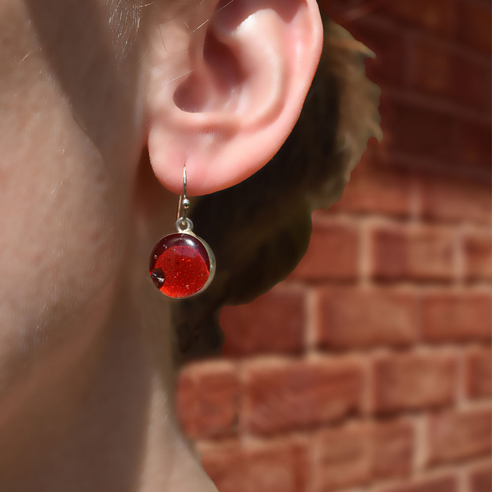 Model wearing the Crash Jewelry Red Mist Dangle Circle Earrings