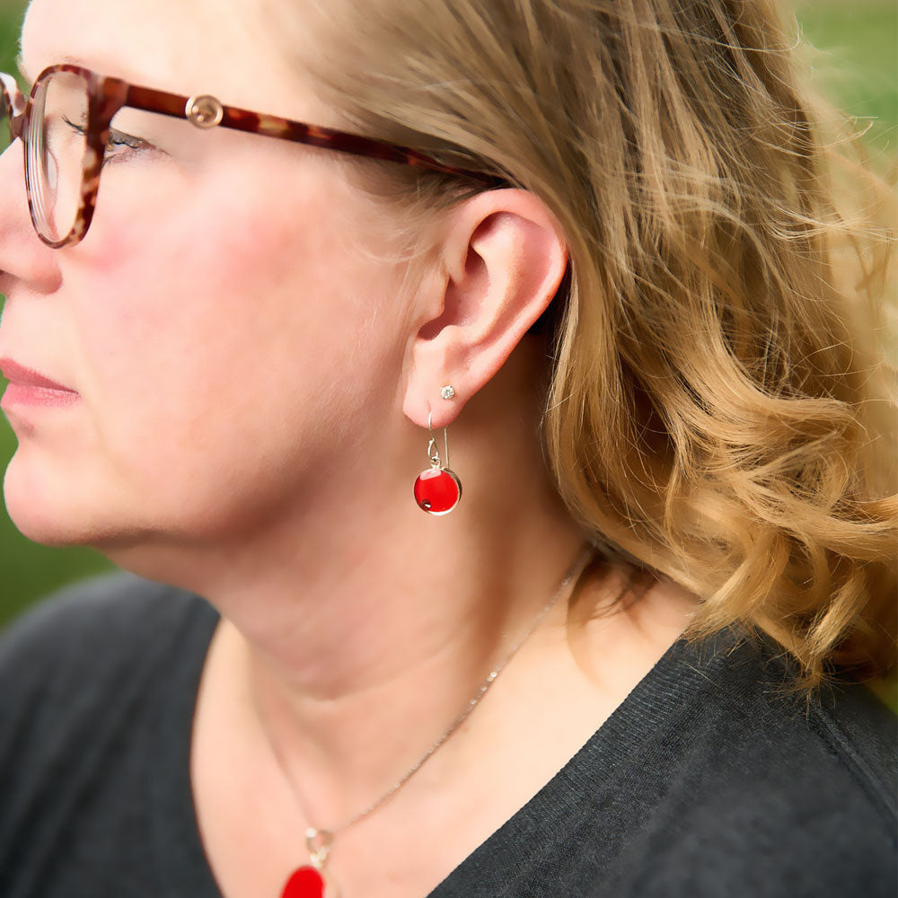 Lady wearing the Crash Jewelry Torch Red Dangle Circle Earrings
