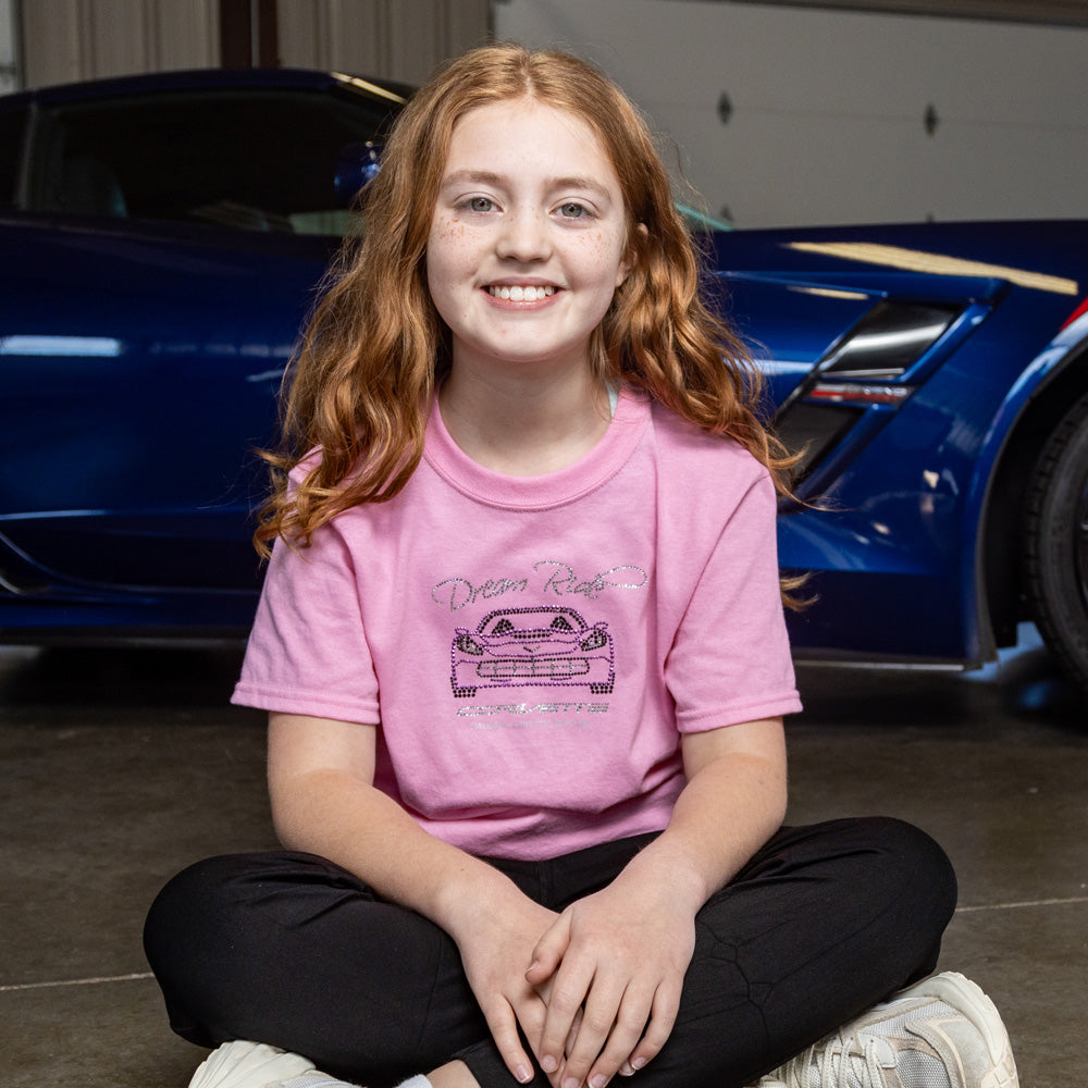 Image of a girl sitting in front of a Corvette wearing the Dream Ride Childrens Pink T-shirt