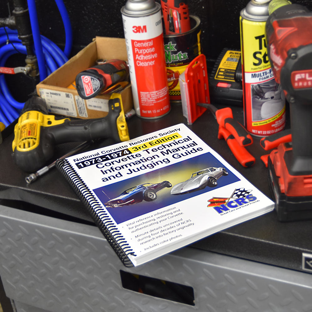 NCRS 1973-1974 Corvette Technical Guide shown on a toolbox in a garage