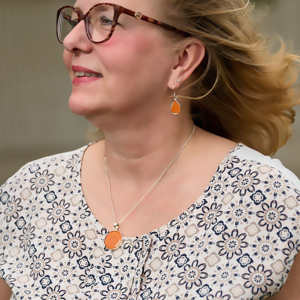 Model wearing the Crash Jewelry Sebring Orange Teardrop Earrings