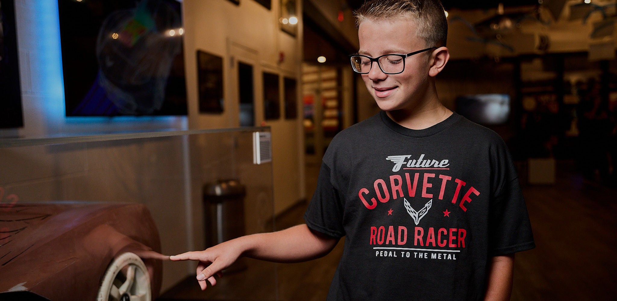 young boy wearing black corvette shirt