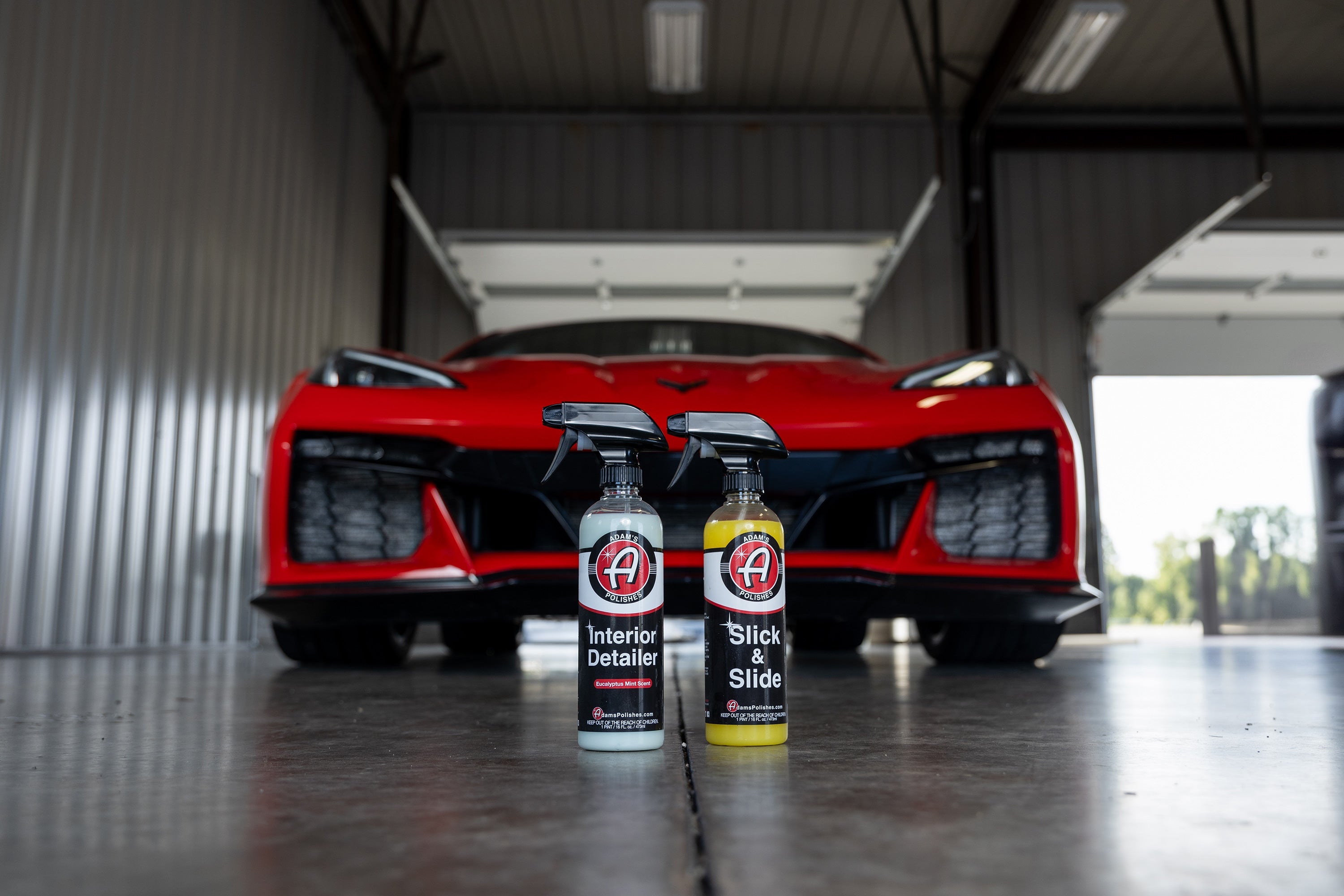 Interior Detail Spray and Slick and Slide spray shown in front of a Corvette