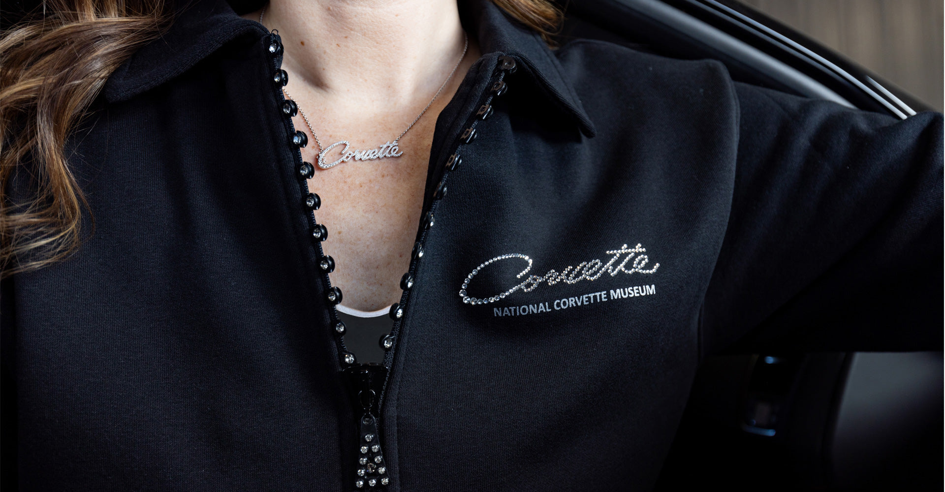 Woman wearing a silver Corvette script necklace